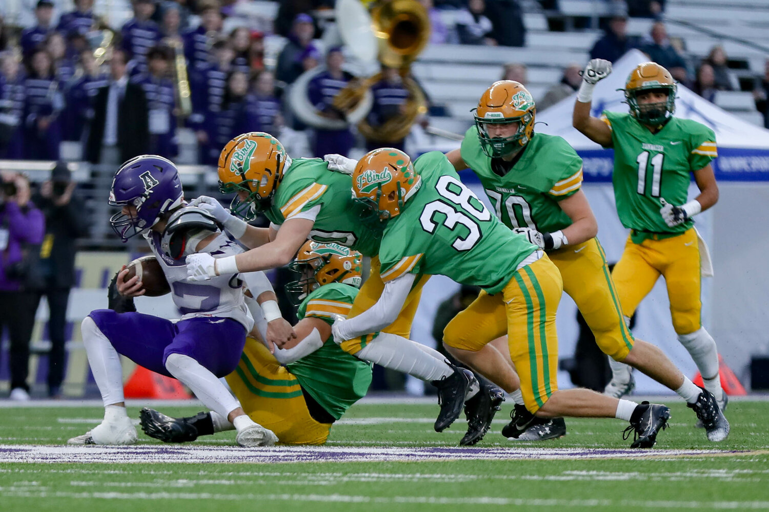 A swarm of Tumwater defenders make a stop during a 60-30 loss to Anacortes Dec. 2. at Husky Stadium.